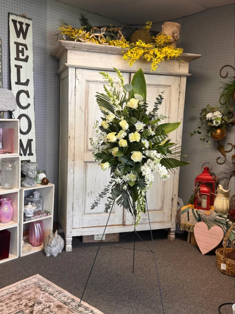 White lily and daisy basket arrangement with fresh greenery